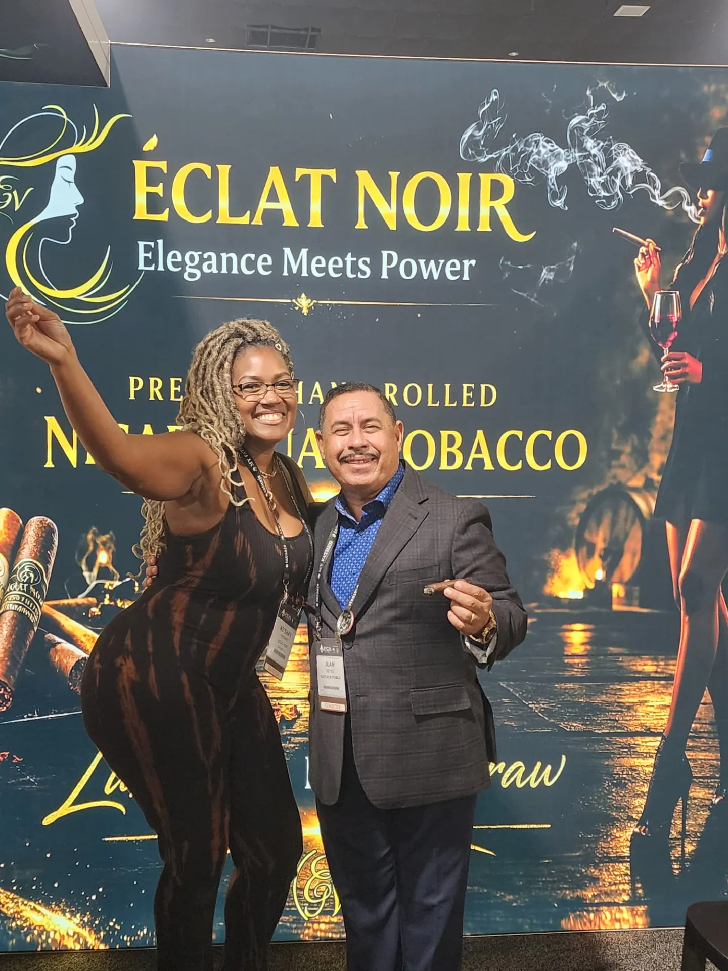 Founder and CEO L. Howard with a fellow exhibitor holding a cigar at the ÉCLAT NOIR booth, PCA Trade Show, New Orleans, April 2026.