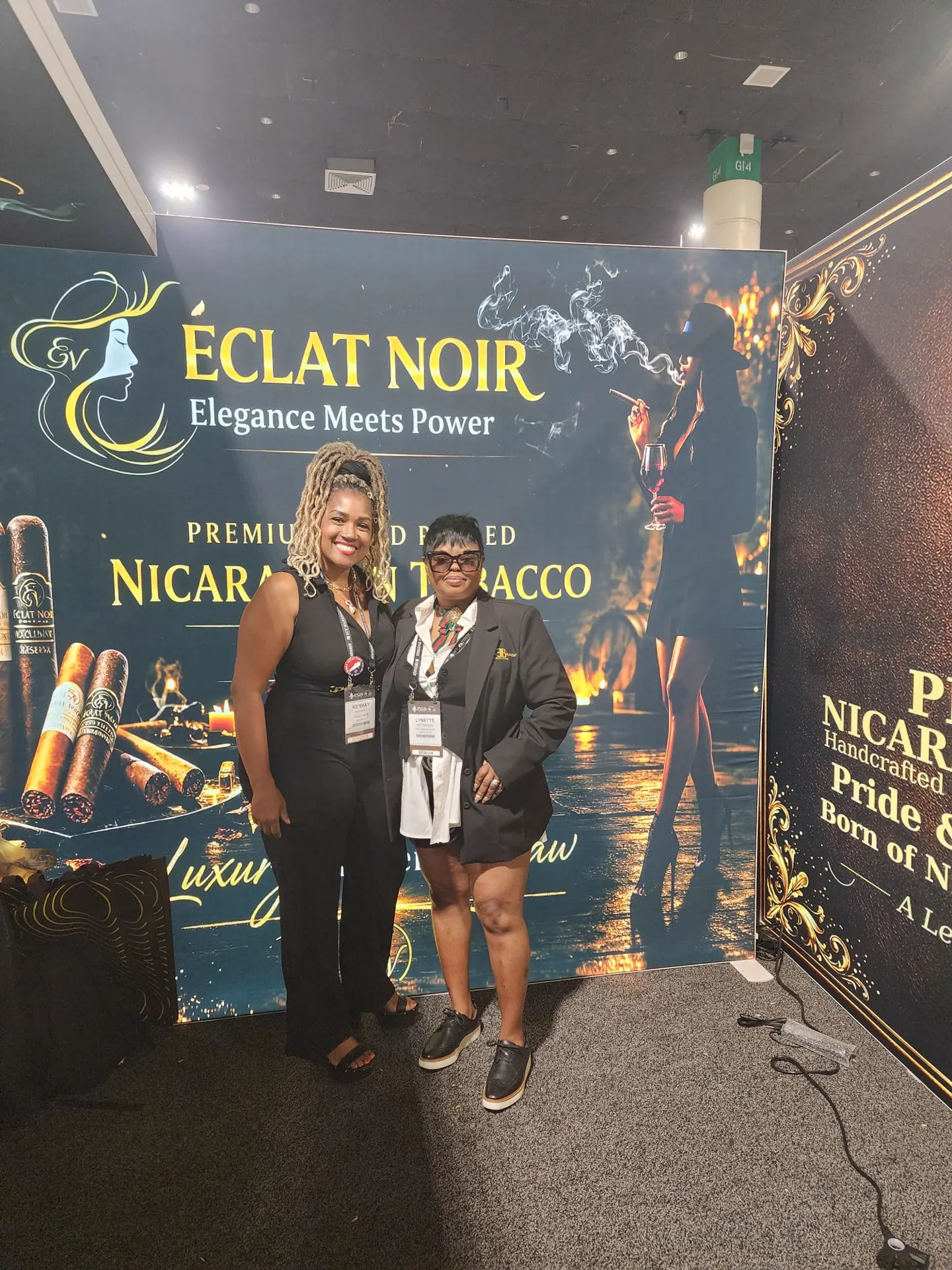 Founder and CEO L. Howard with a retailer in front of the ÉCLAT NOIR booth banner, PCA Trade Show, New Orleans, April 2026.