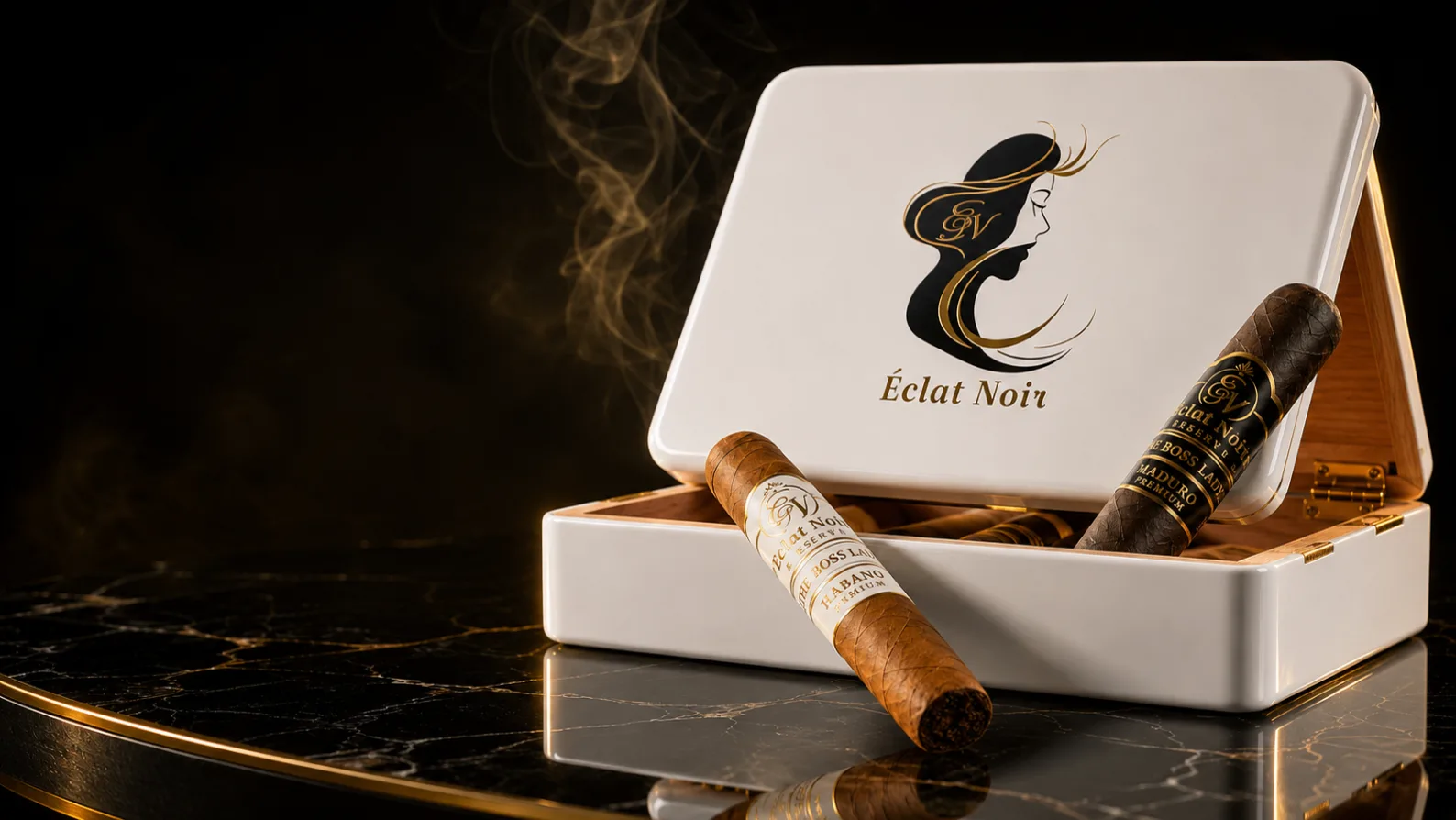 ÉCLAT NOIR white lacquer presentation box open, gold face mark on the lid, Habano and Maduro cigars resting alongside.