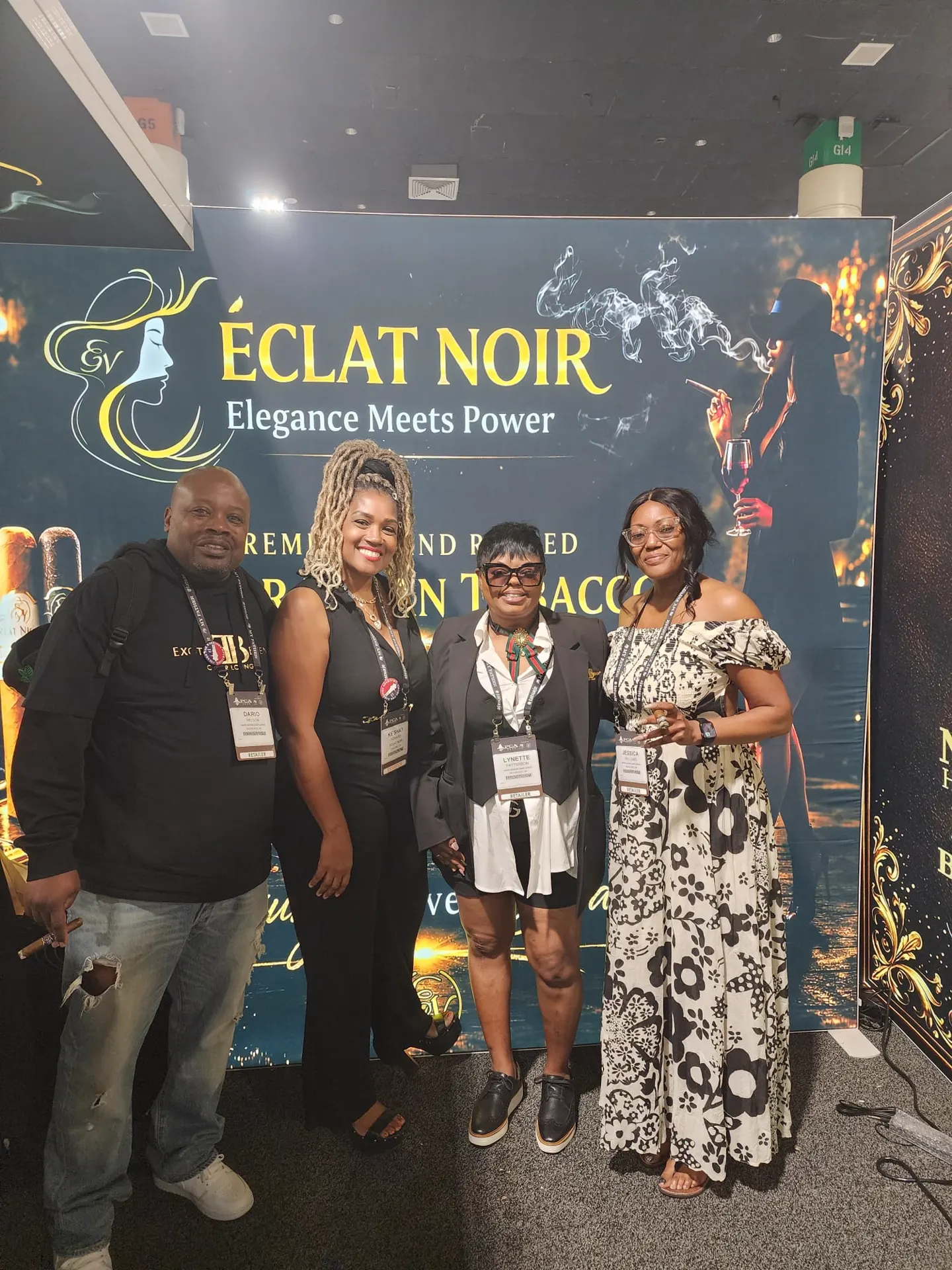 Founder and CEO L. Howard with three retailers gathered in front of the ÉCLAT NOIR booth banner, PCA Trade Show, New Orleans, April 2026.